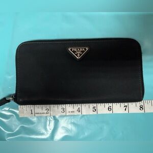 Prada black tessuto nylon & leather zip-around wallet enameled triangle logo.